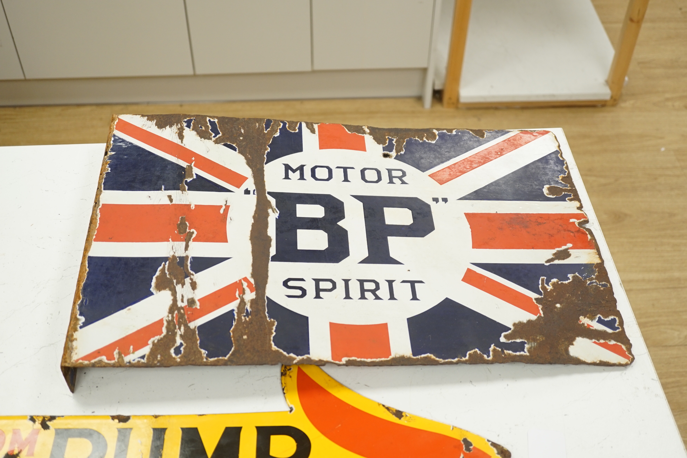 Three enamel advertising signs including BP Motor Spirit and Sphinx Plugs, largest 61cm wide